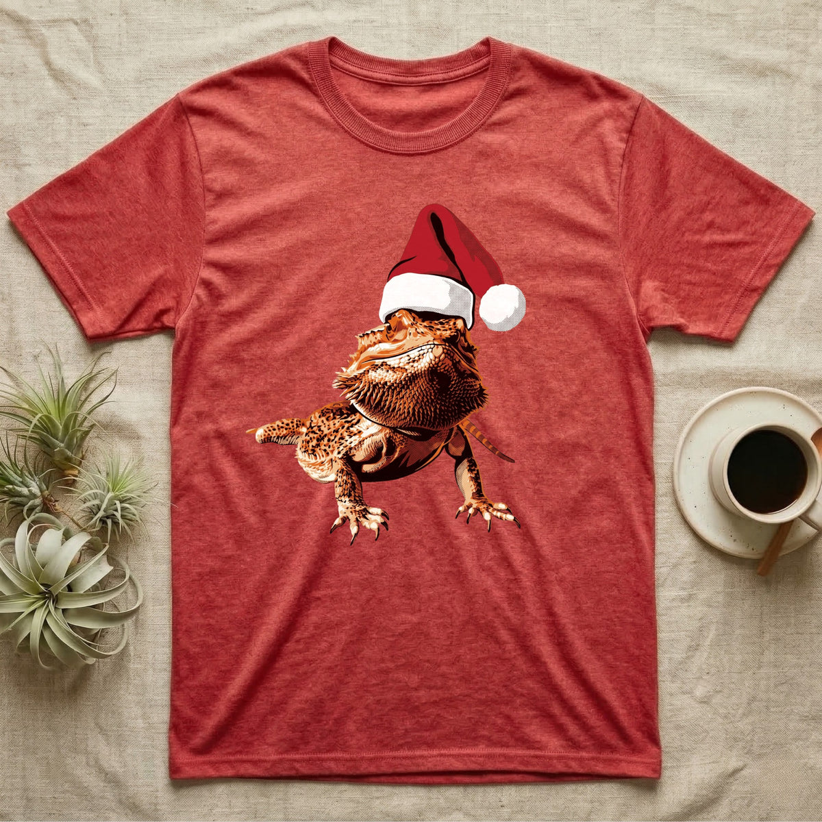 Vintage comic illustration of a bearded dragon wearing a red and white Santa hat, graphic-only, no text. — shown on a Heather Red tee.
