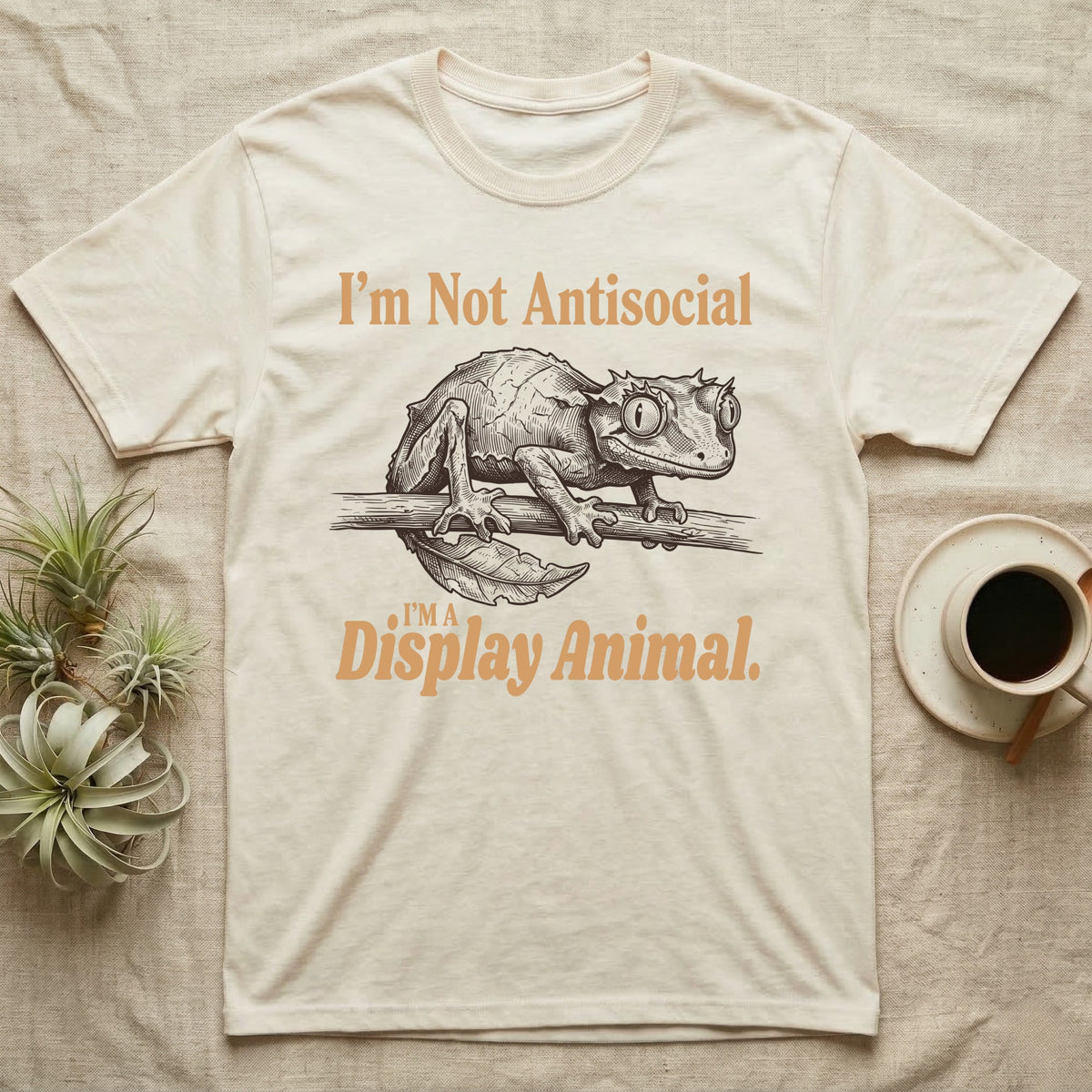 Leaf-Tailed Gecko Display T-Shirt in Natural — Engraved satanic leaf-tailed gecko on a branch staring out, with the words I'm Not Antisocial, I'm a Display Animal