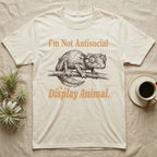 Leaf-Tailed Gecko Display T-Shirt in Natural — Engraved satanic leaf-tailed gecko on a branch staring out, with the words I'm Not Antisocial, I'm a Display Animal