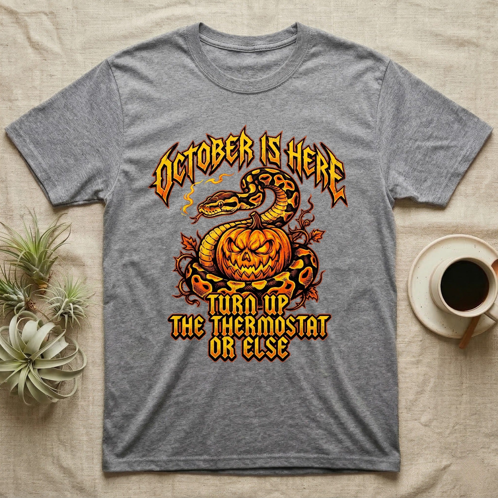 Ball Python October Thermostat T-Shirt in Sport Grey — Metal-band style ball python coiled over a glowing jack-o'-lantern, "October Is Here, Turn Up the Thermostat Or Else."