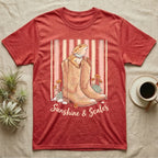 Red heather t-shirt with boots, lizard, and text "Sunshine & Scales".