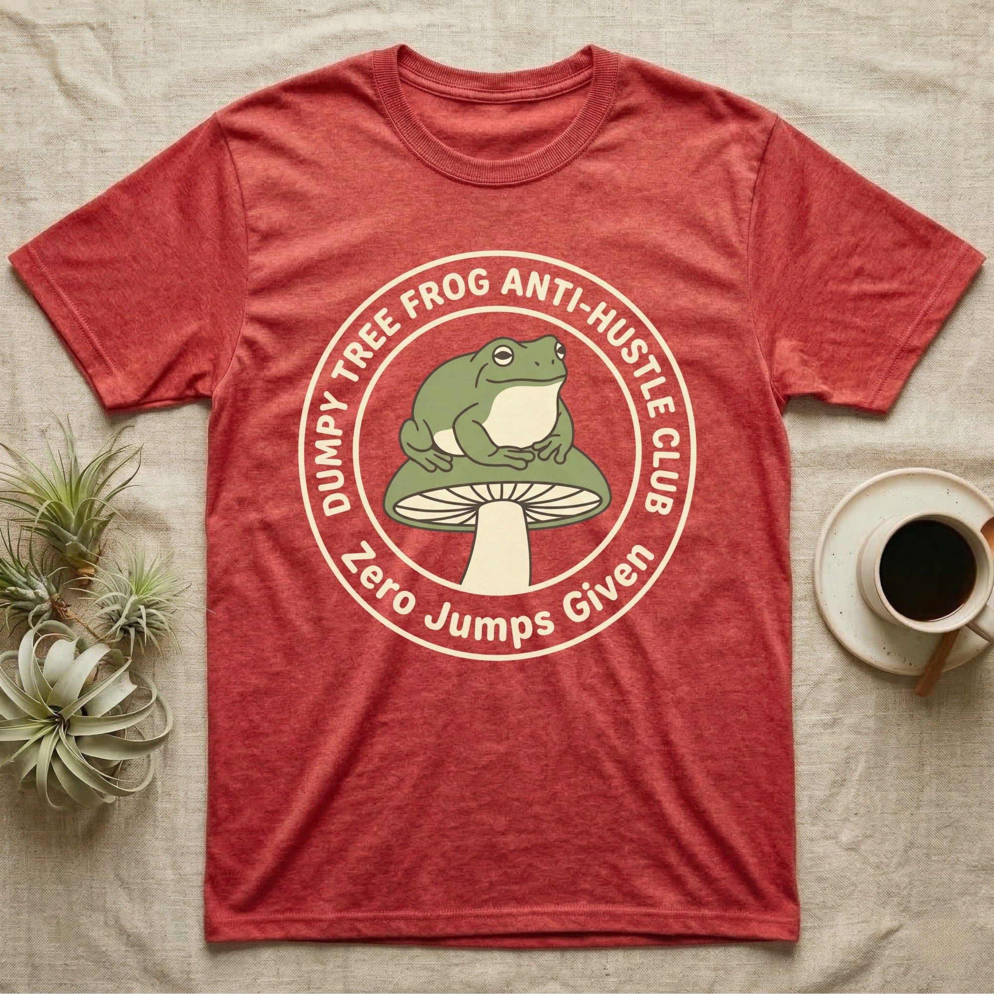 Red t-shirt with a frog on a mushroom and text "Dumpy Tree Frog Anti-Hustle Club Zero Jumps Given".