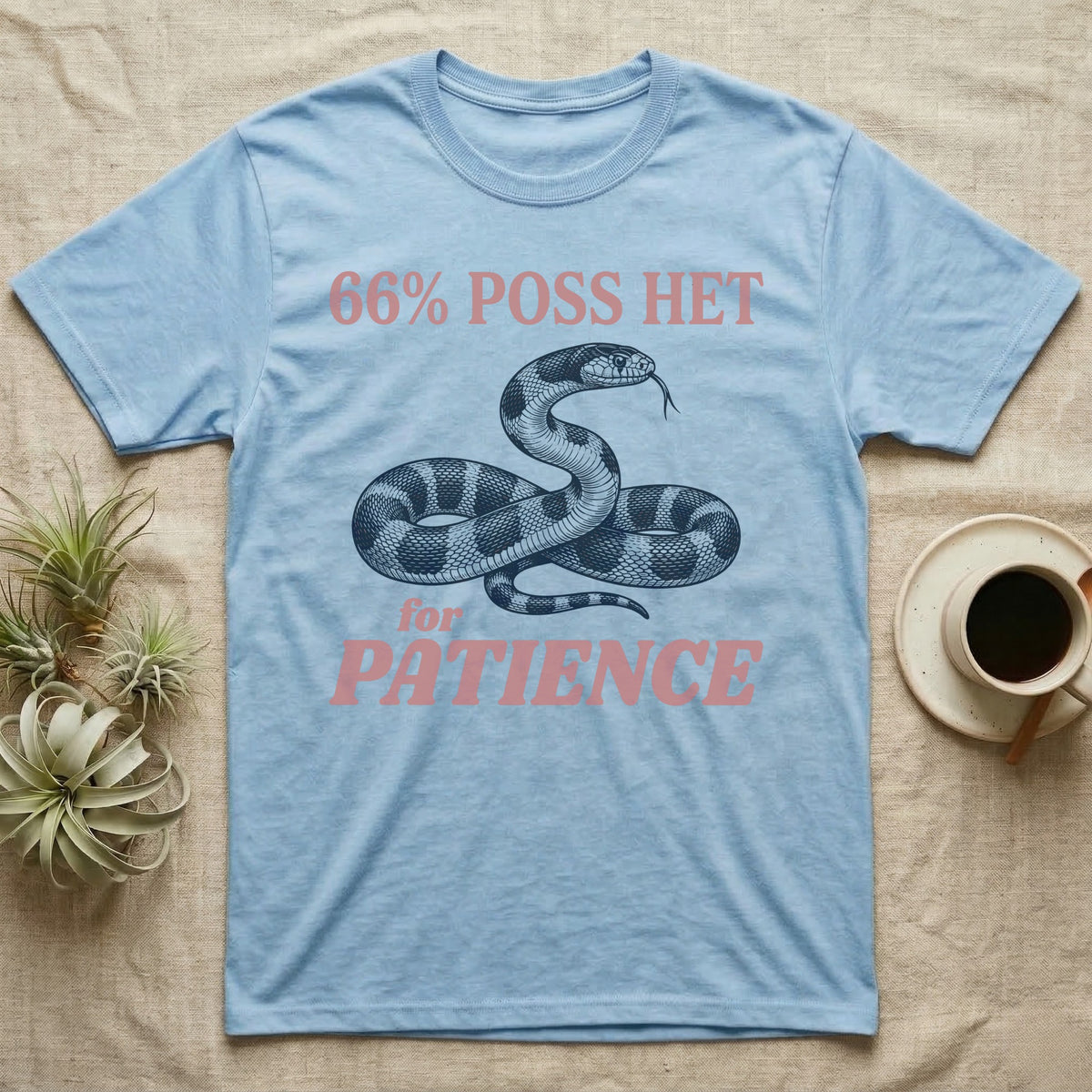 Kingsnake Patience T-Shirt in Light Blue — Navy engraving of a banded California kingsnake head raised and tongue flicking, between 66% POSS HET and for PATIENCE in rose type