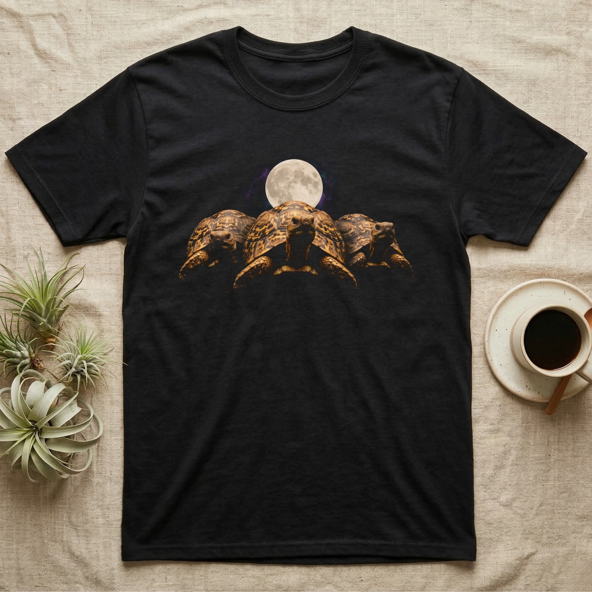 Leopard Tortoise Moon T-Shirt in Black — Three leopard tortoises facing out under a full moon and nebula, dissolving into black.