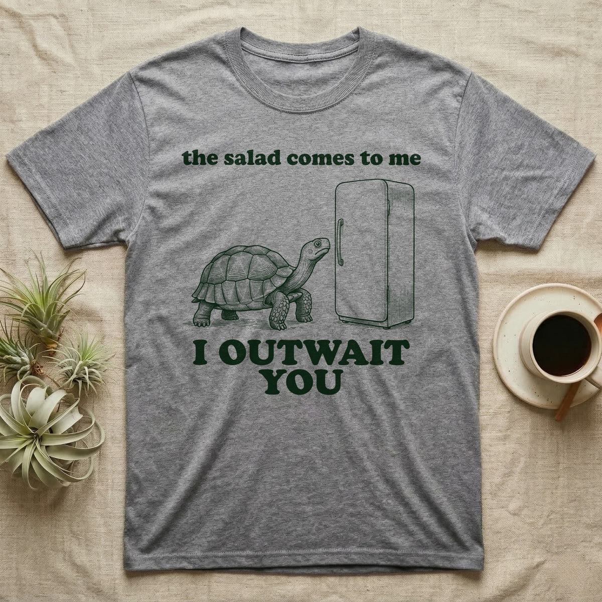Sulcata Fridge Standoff T-Shirt in Sport Grey — Engraved sulcata tortoise waiting in front of a closed fridge between the words the salad comes to me and I OUTWAIT YOU.