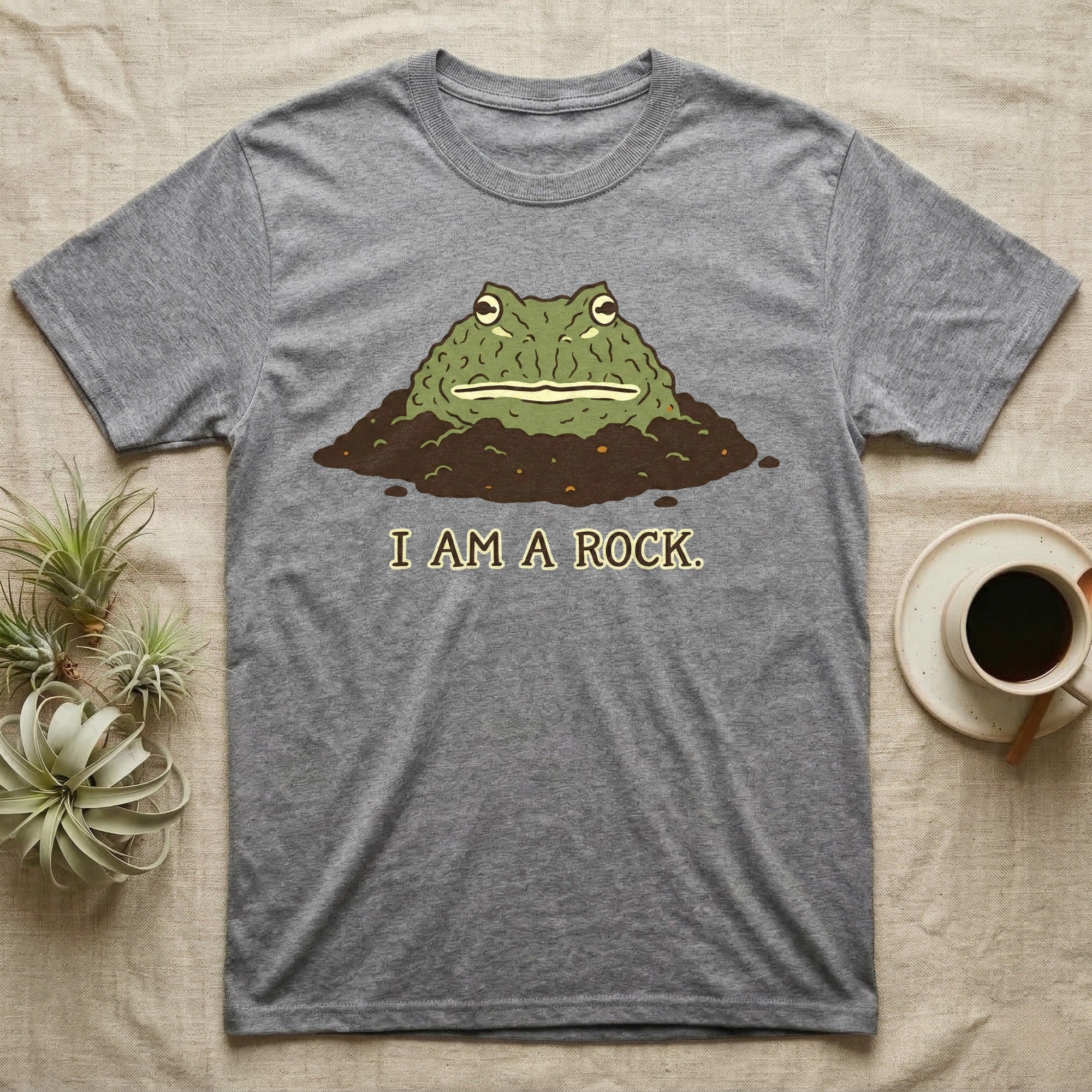 Gray t-shirt with cartoon frog emerging from dirt, text "I AM A ROCK."