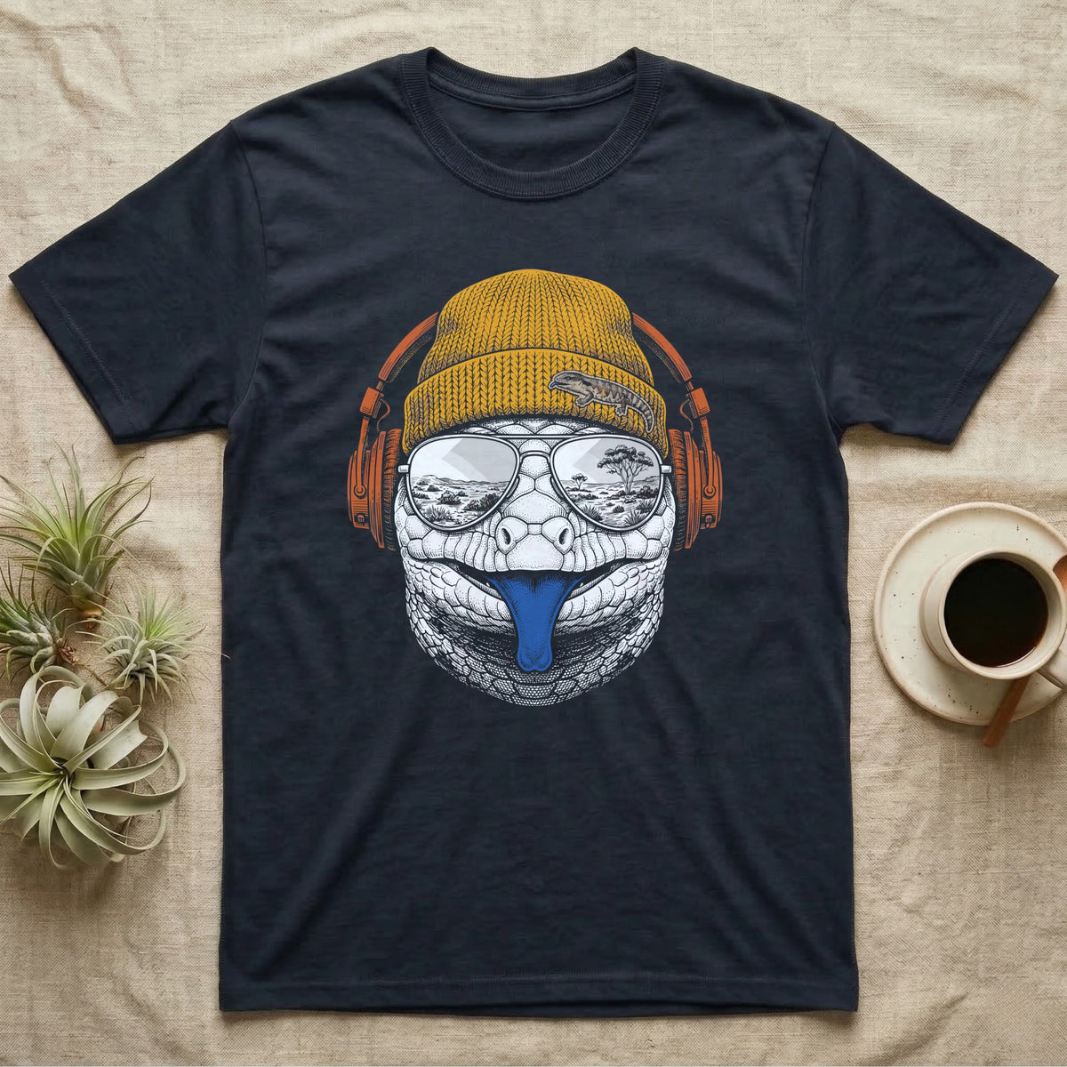 Blue-Tongued Skink Headphones T-Shirt in Navy — Engraved blue-tongued skink with cobalt tongue out, wearing a beanie and headphones, aviators reflecting the outback.