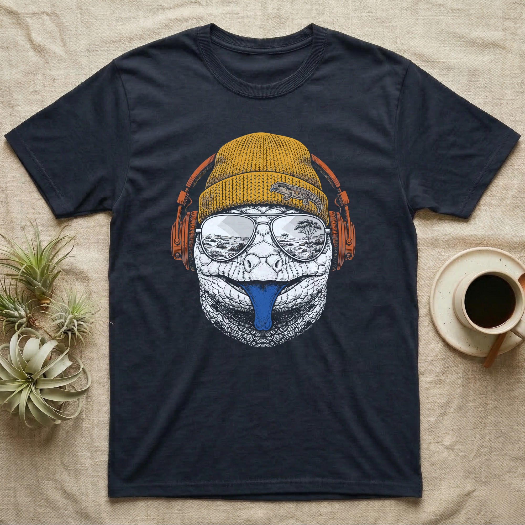 Blue-Tongued Skink Headphones T-Shirt in Navy — Engraved blue-tongued skink with cobalt tongue out, wearing a beanie and headphones, aviators reflecting the outback.