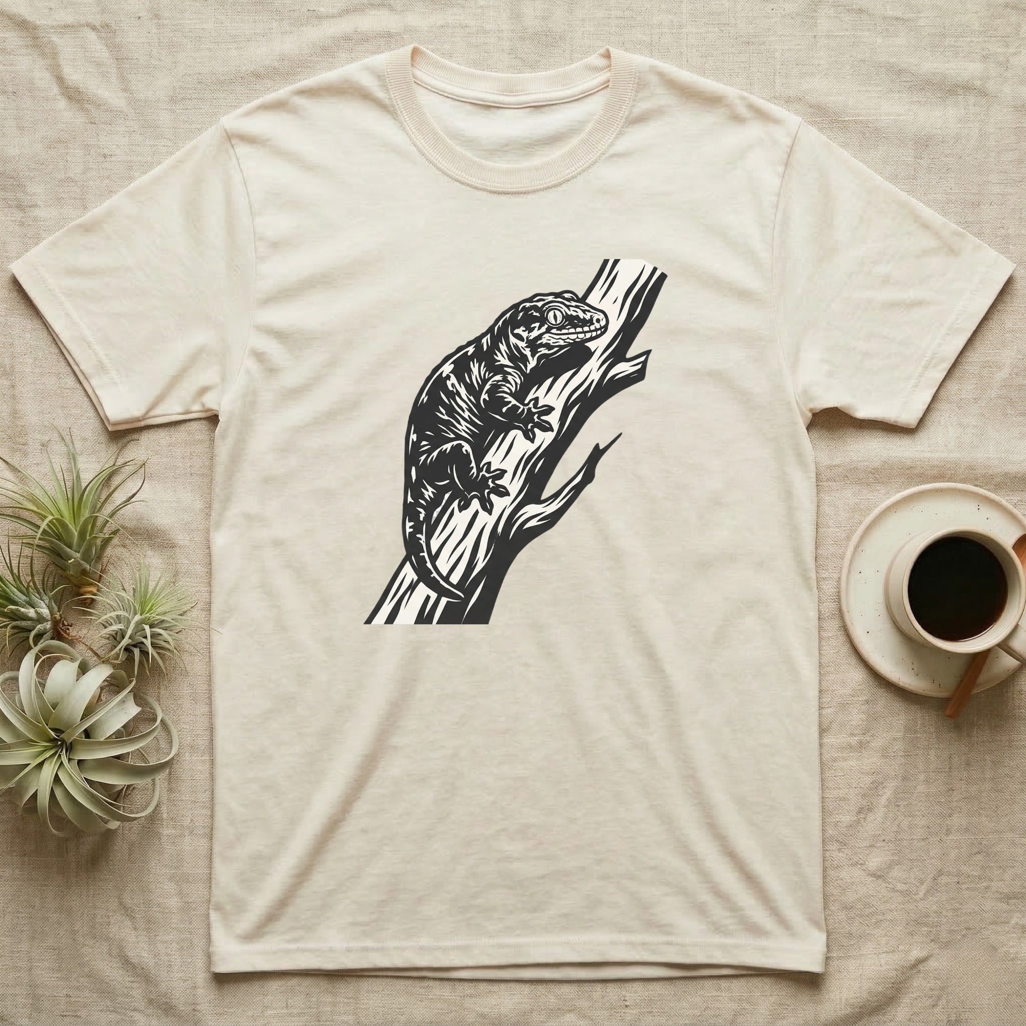 Cream t-shirt with black lizard graphic on a branch.