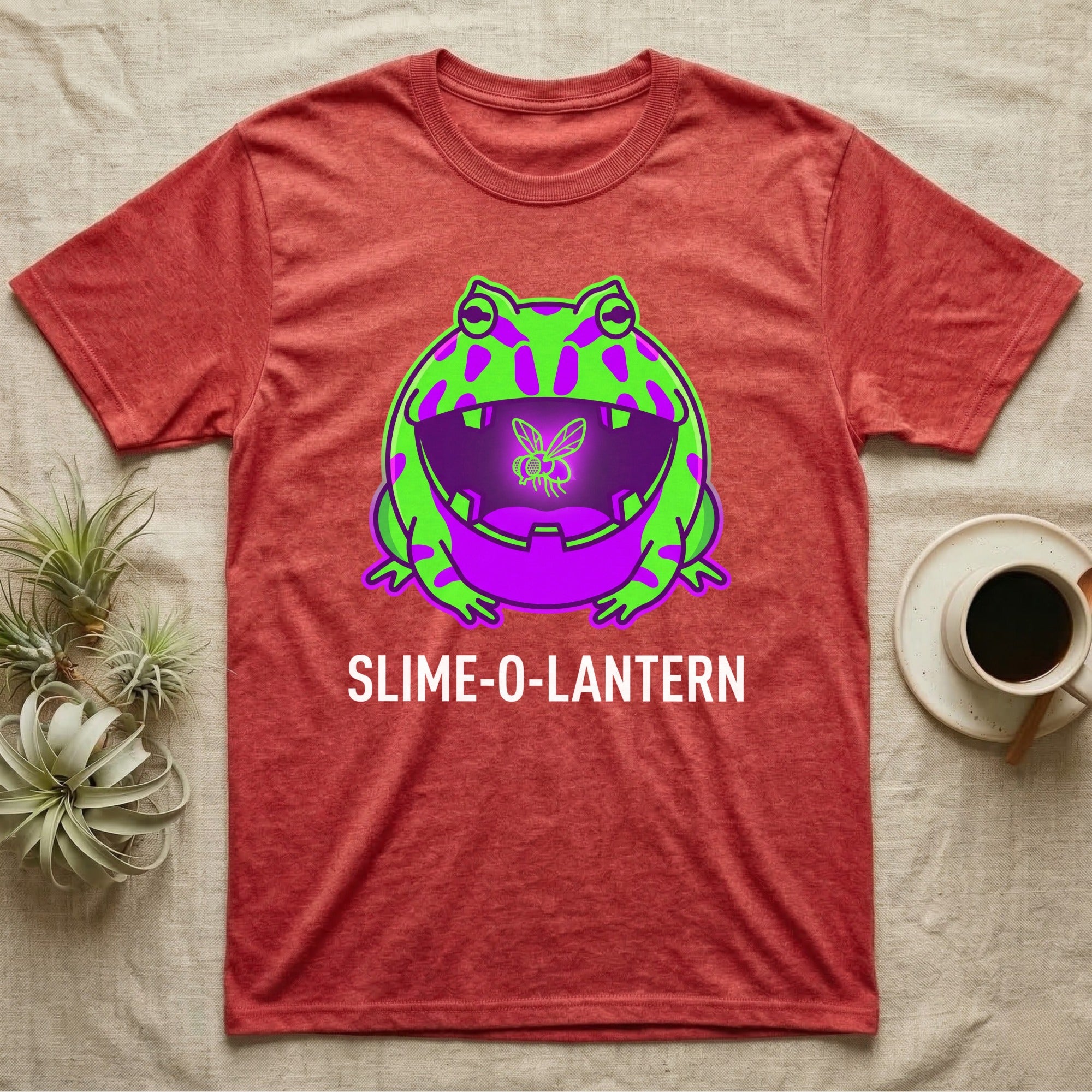 Pacman Frog Slime-O-Lantern T-Shirt in Heather Red — Neon pop-art Pacman frog shaped like a jack-o'-lantern with a lit fly in its mouth, "Slime-O-Lantern."