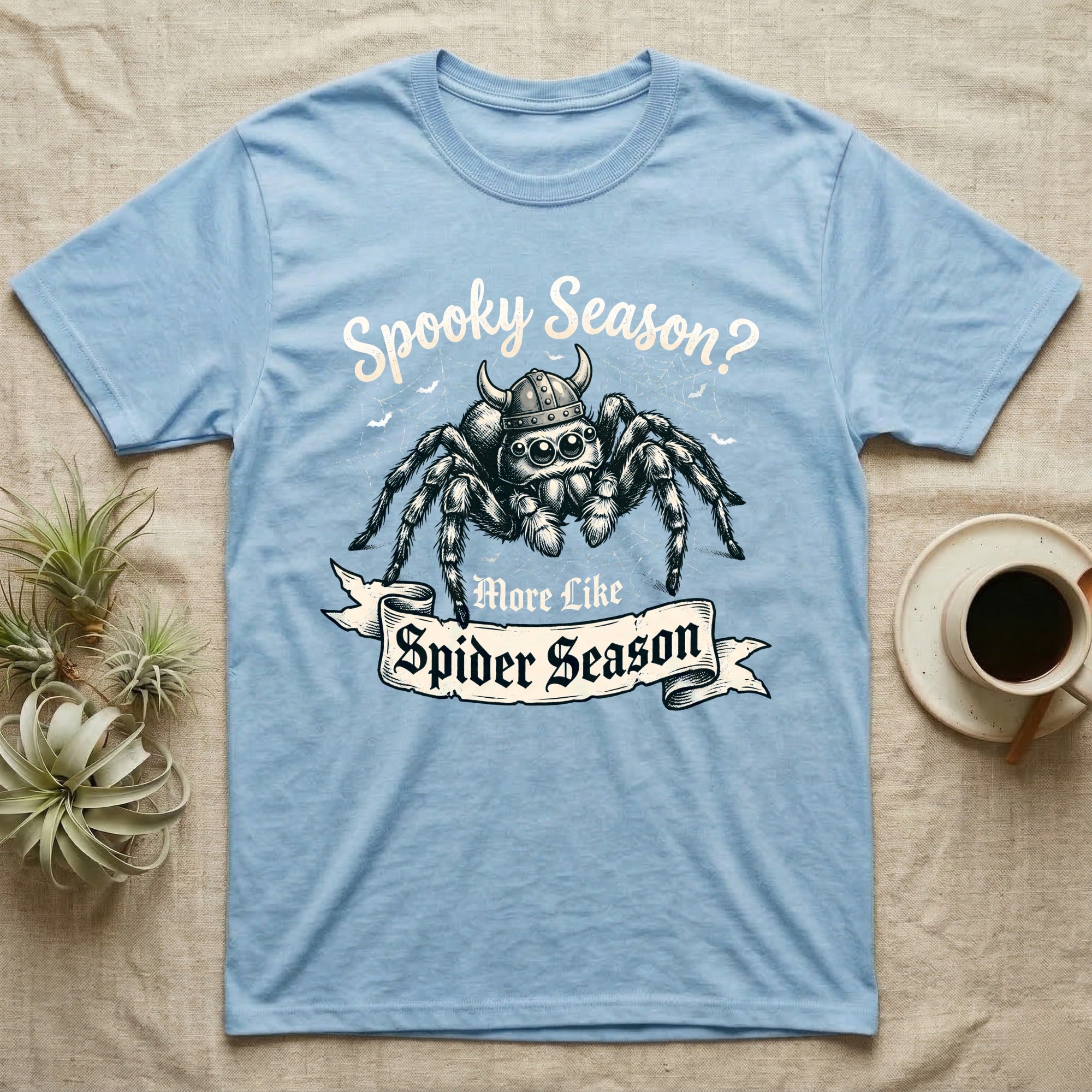 Jumping Spider Viking Helmet T-Shirt in Light Blue — Ink-sketch jumping spider in a Viking helmet over a web, banner reading "More Like Spider Season."