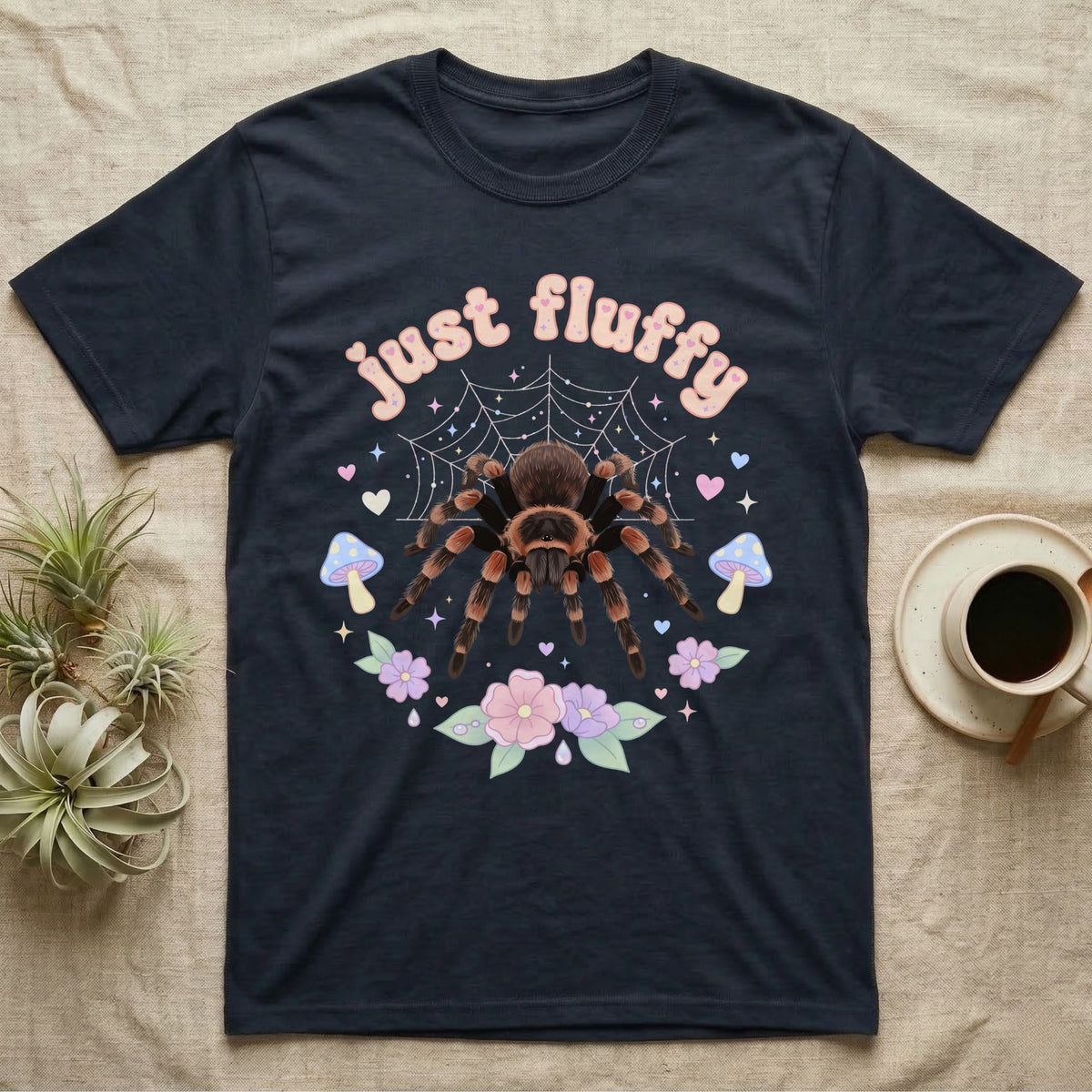Mexican Redknee Tarantula Baby T-Shirt in Navy — Fuzzy Mexican redknee tarantula on a pastel web with blossoms under puffy peach bubble text "just fluffy".