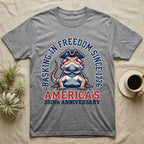 Bearded Dragon Basking T-Shirt in Sport Grey — Sports-logo bearded dragon in a tricorn hat under a collegiate arch reading Basking in Freedom Since 1776.