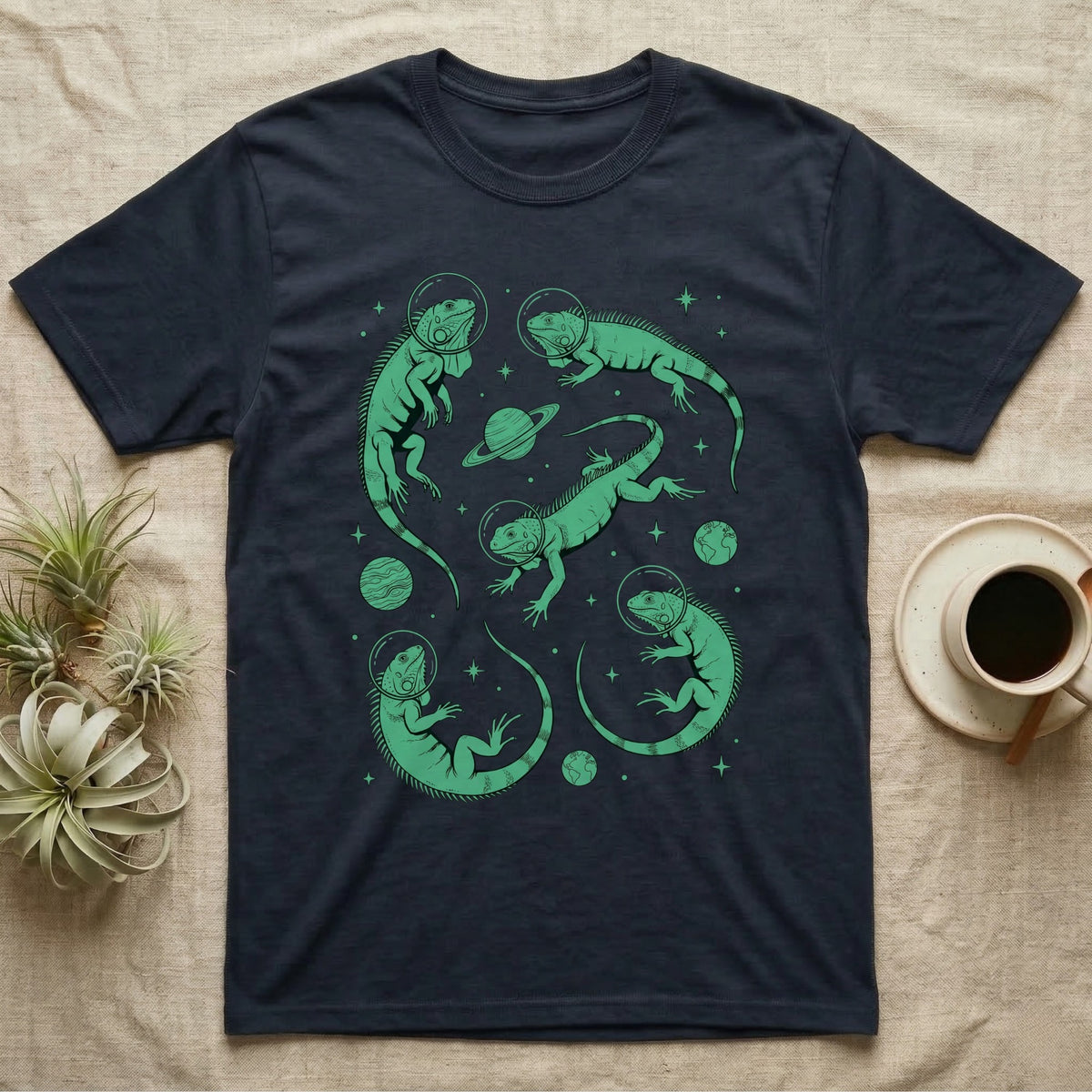 Green Iguana Cosmic T-Shirt in Navy — Vintage screen-print illustration of green iguanas in astronaut helmets floating in space, cosmic emerald green monochromatic on dark background.