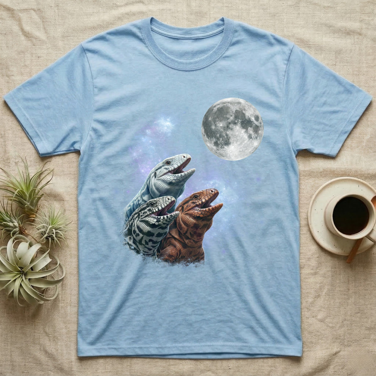 Tegu Moon Howl T-Shirt in Light Blue — Three Tegu colour morphs howling at a full moon over a nebula on a dark grey t-shirt.