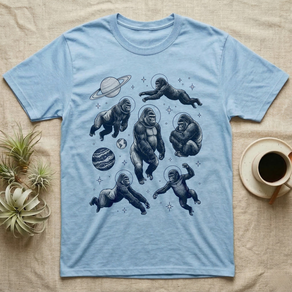 Blue t-shirt with illustration of gorillas in space wearing astronaut helmets.