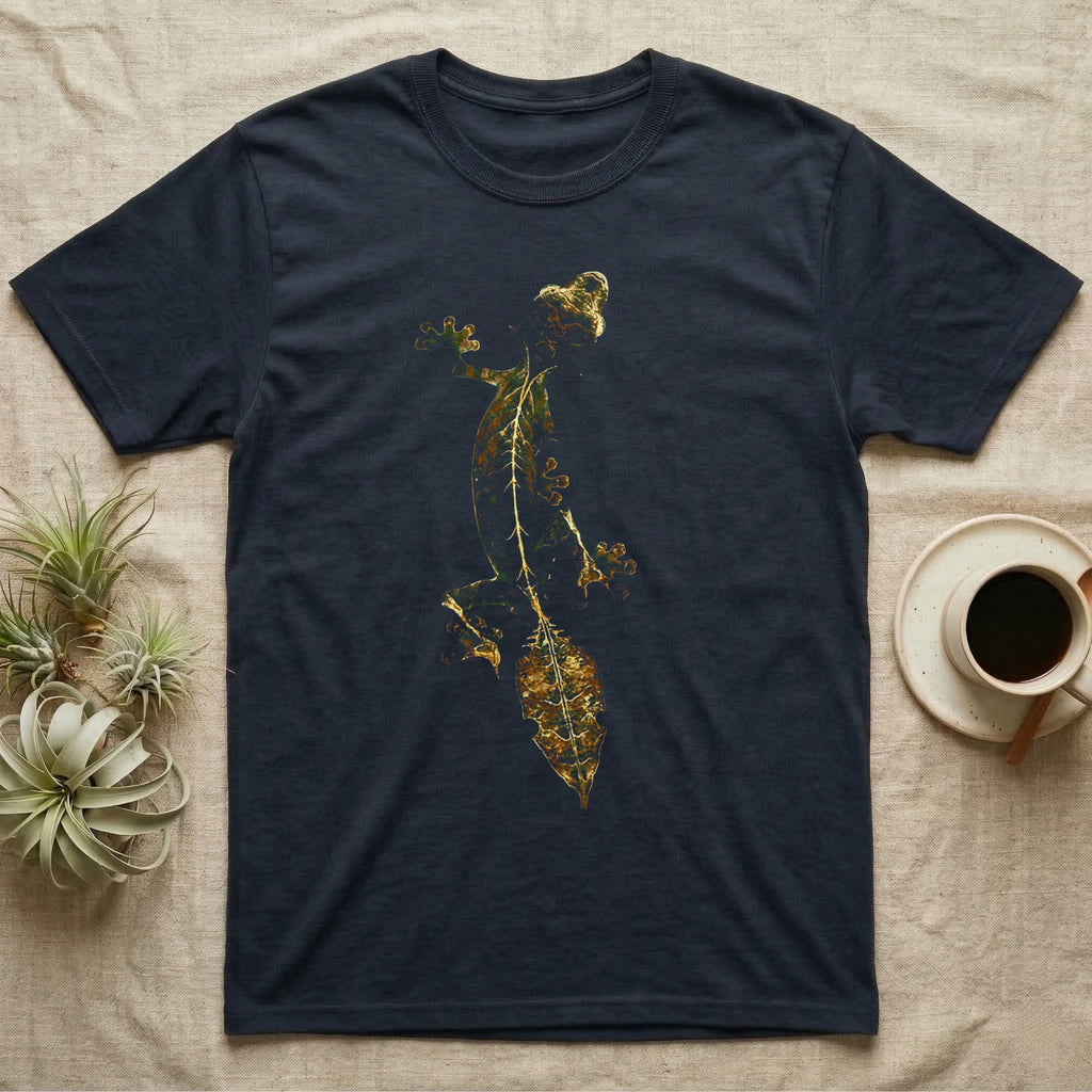 Full-body illustration of an eyelash leaf-tailed gecko mid-climb with a mottled olive-and-gold leaf-shaped tail blending into camouflage texture, no on-shirt text. — shown on a Navy tee.
