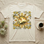 Cream t-shirt with a stylized hamster and yellow floral design.