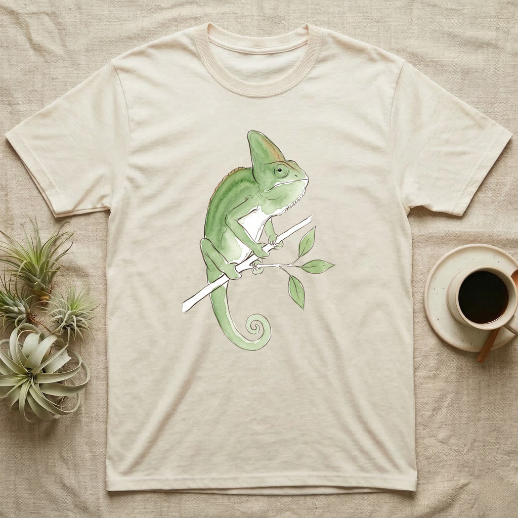 Veiled Chameleon Ambassador T-Shirt in Natural — Watercolour illustration of a veiled chameleon calmly gripping a slender branch, tall casque and curled tail.