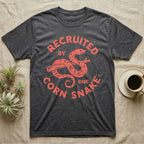 Corn Snake Recruit T-Shirt in Dark Heather — Hand-carved block-print badge of a corn snake on a branch inside ring lettering reading Recruited By One Corn Snake.