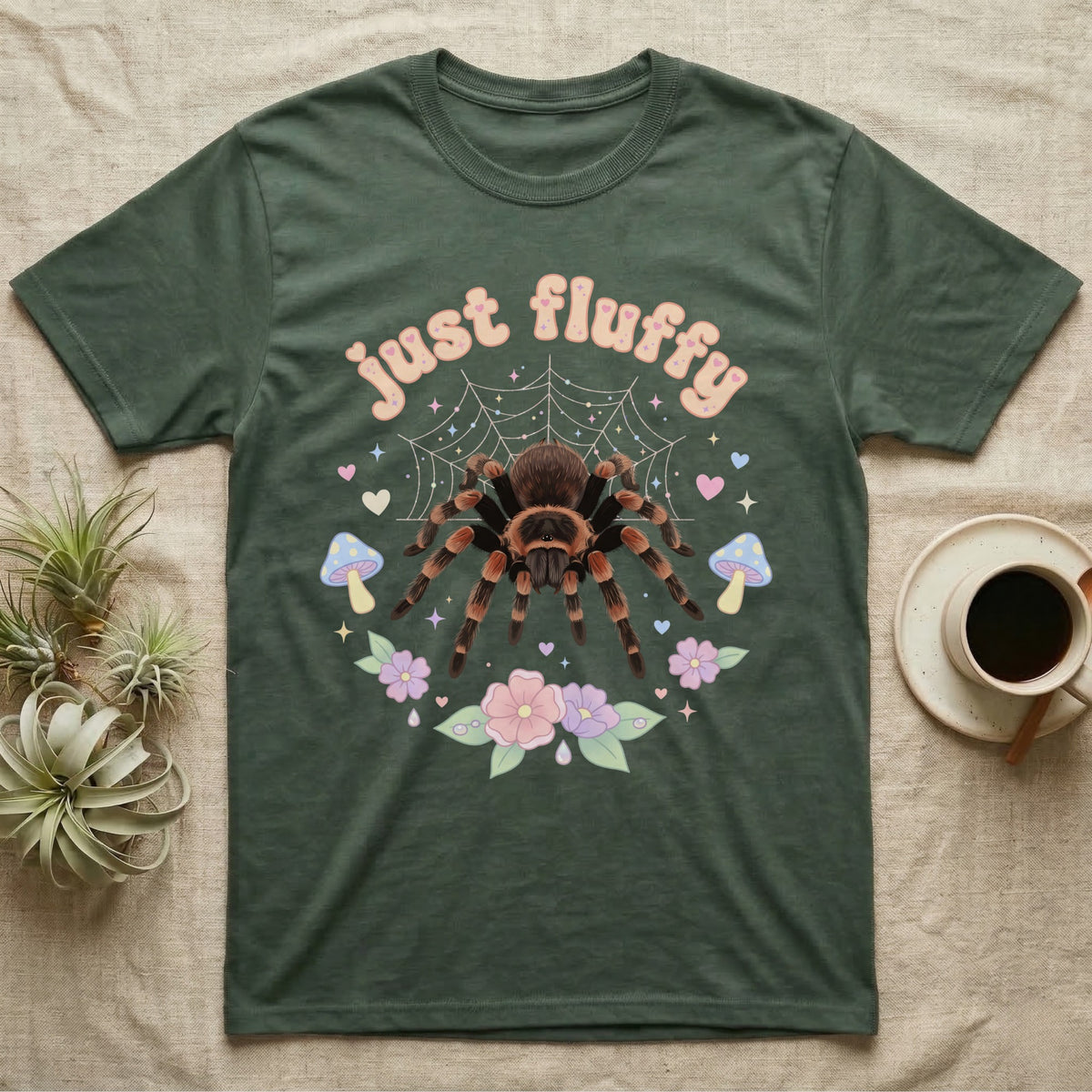 Mexican Redknee Tarantula Baby T-Shirt in Military Green — Fuzzy Mexican redknee tarantula on a pastel web with blossoms under puffy peach bubble text "just fluffy".