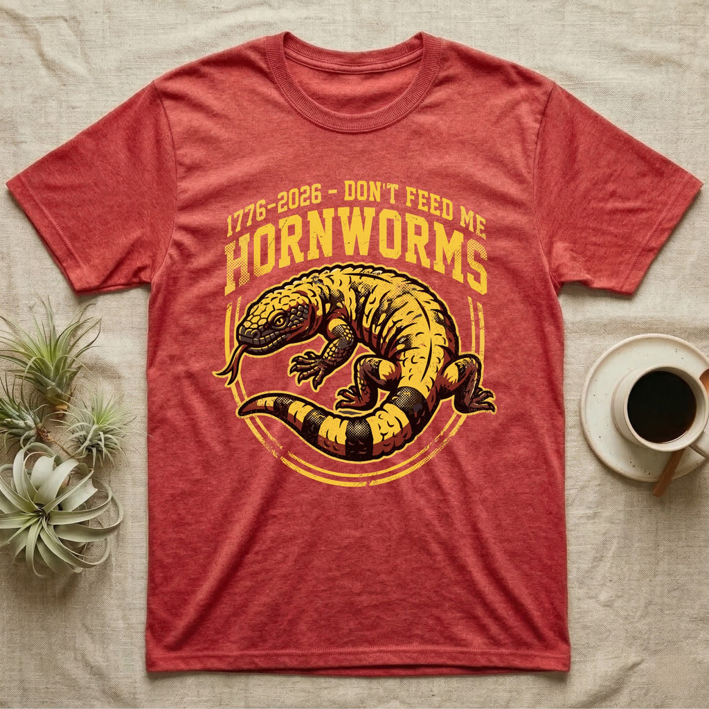 Gila Monster Hornworms Tee in Heather Red — Bold gold and maroon woodcut tee of a Gila monster with banded tail, large text reading Don't Feed Me Hornworms, on black.