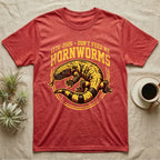 Gila Monster Hornworms Tee in Heather Red — Bold gold and maroon woodcut tee of a Gila monster with banded tail, large text reading Don't Feed Me Hornworms, on black.