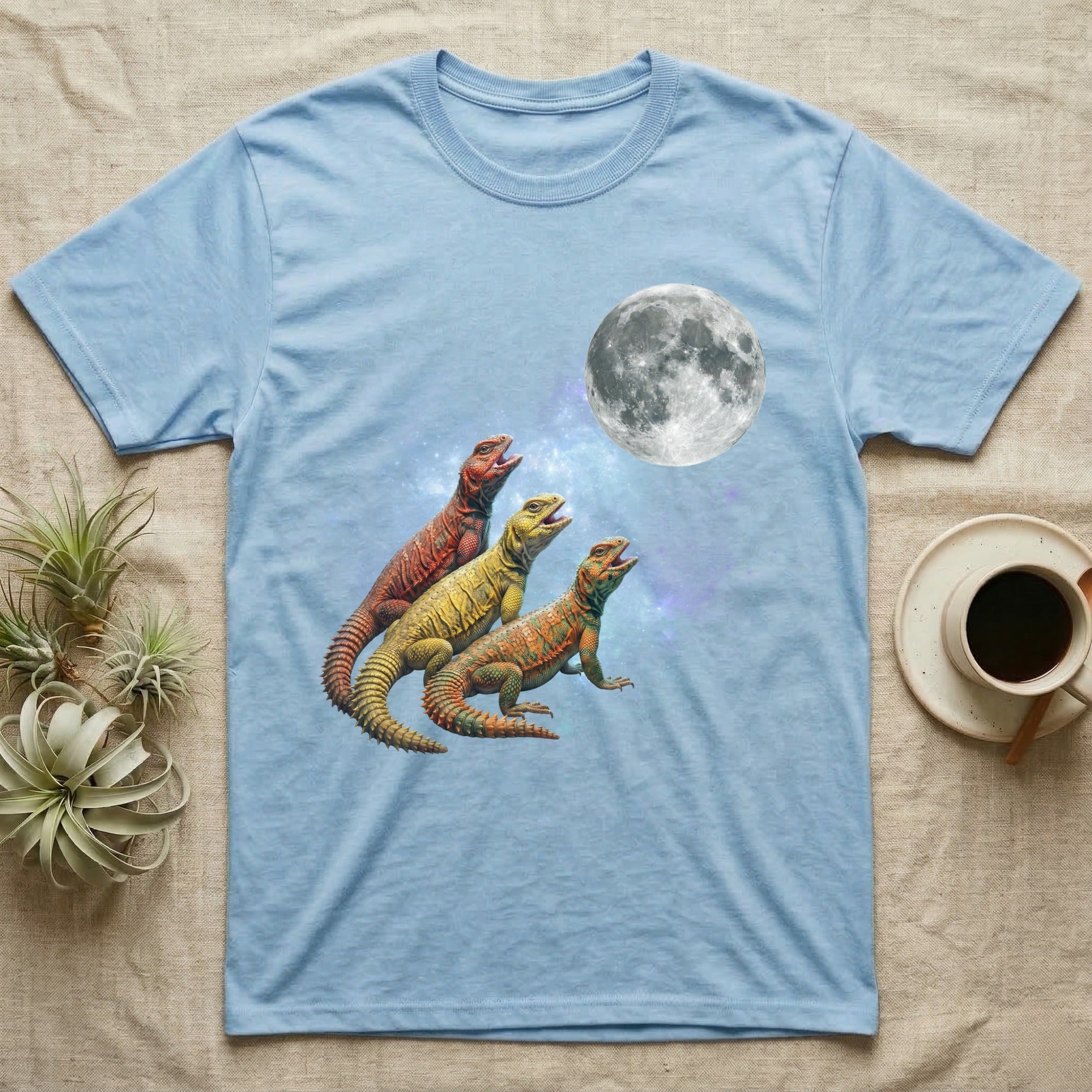 Uromastyx Moon Howl T-Shirt in Light Blue — Three Uromastyx colour morphs howling at a full moon over a nebula on a dark grey t-shirt.