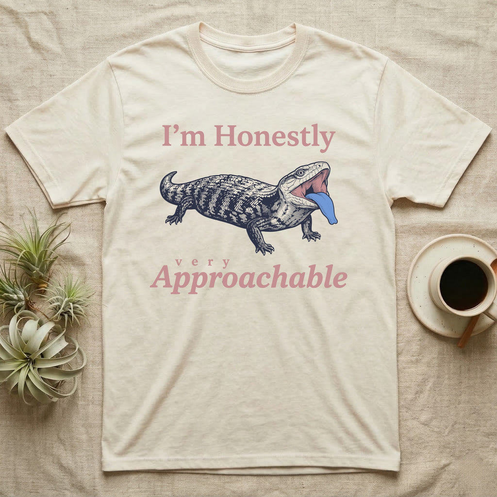 Blue-Tongued Skink Hiss T-Shirt in Natural — Navy engraving of a hissing blue-tongued skink with its bright blue tongue out between the words I'm Honestly and very Approachable