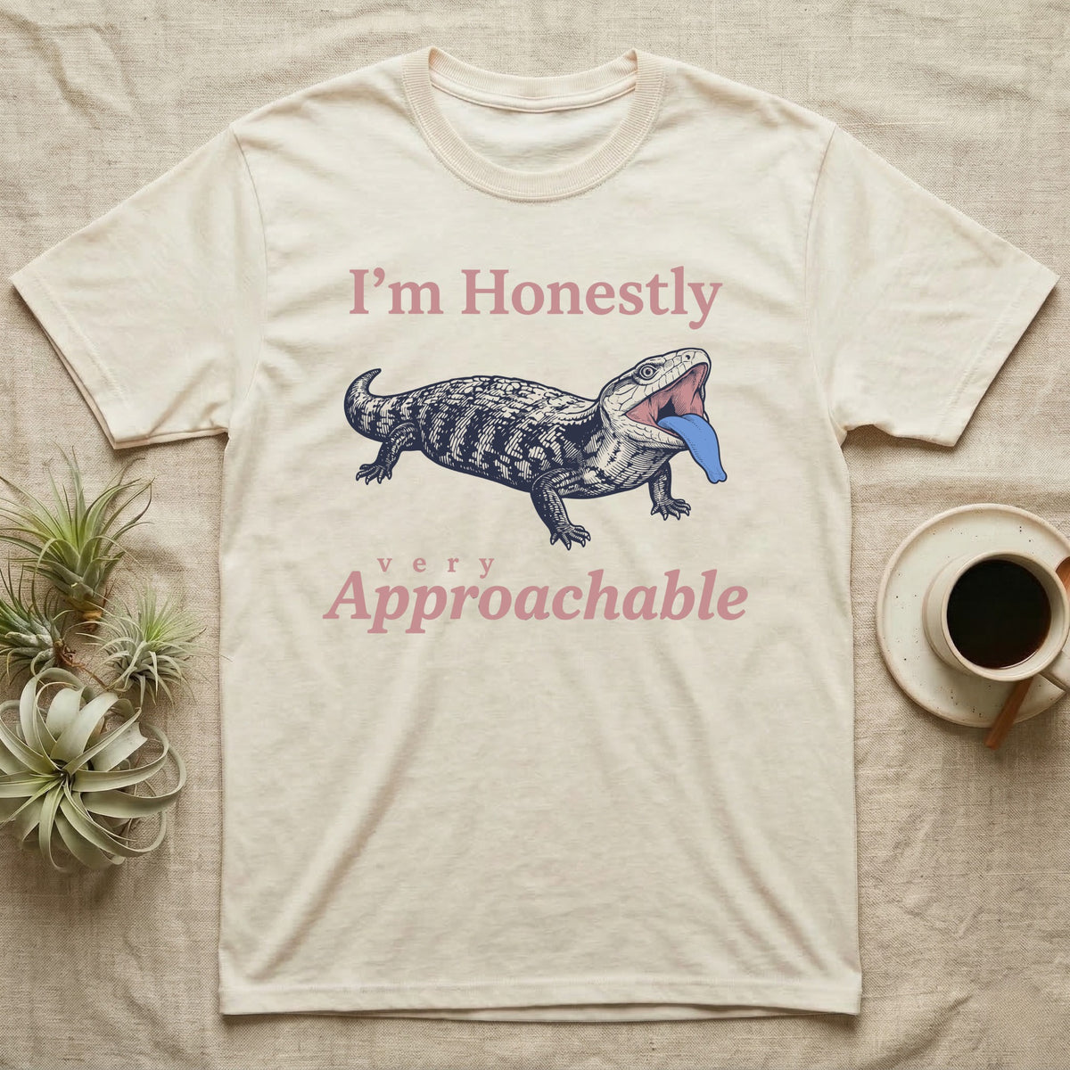 Blue-Tongued Skink Hiss T-Shirt in Natural — Navy engraving of a hissing blue-tongued skink with its bright blue tongue out between the words I'm Honestly and very Approachable