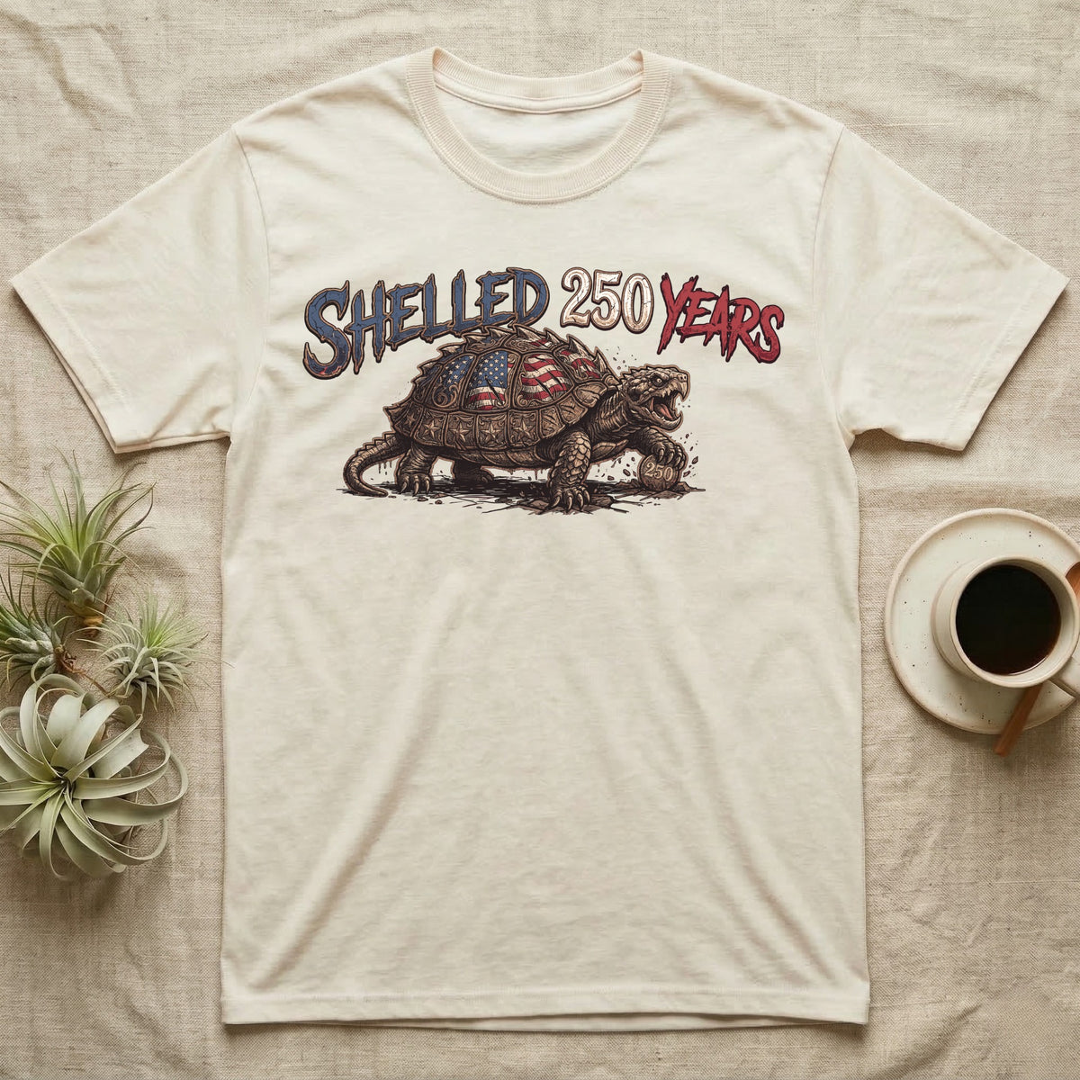Snapping Turtle 250 T-Shirt in Natural — Gritty woodcut alligator snapping turtle with a flag-etched shell on a 250 coin under text Shelled 250 Years.