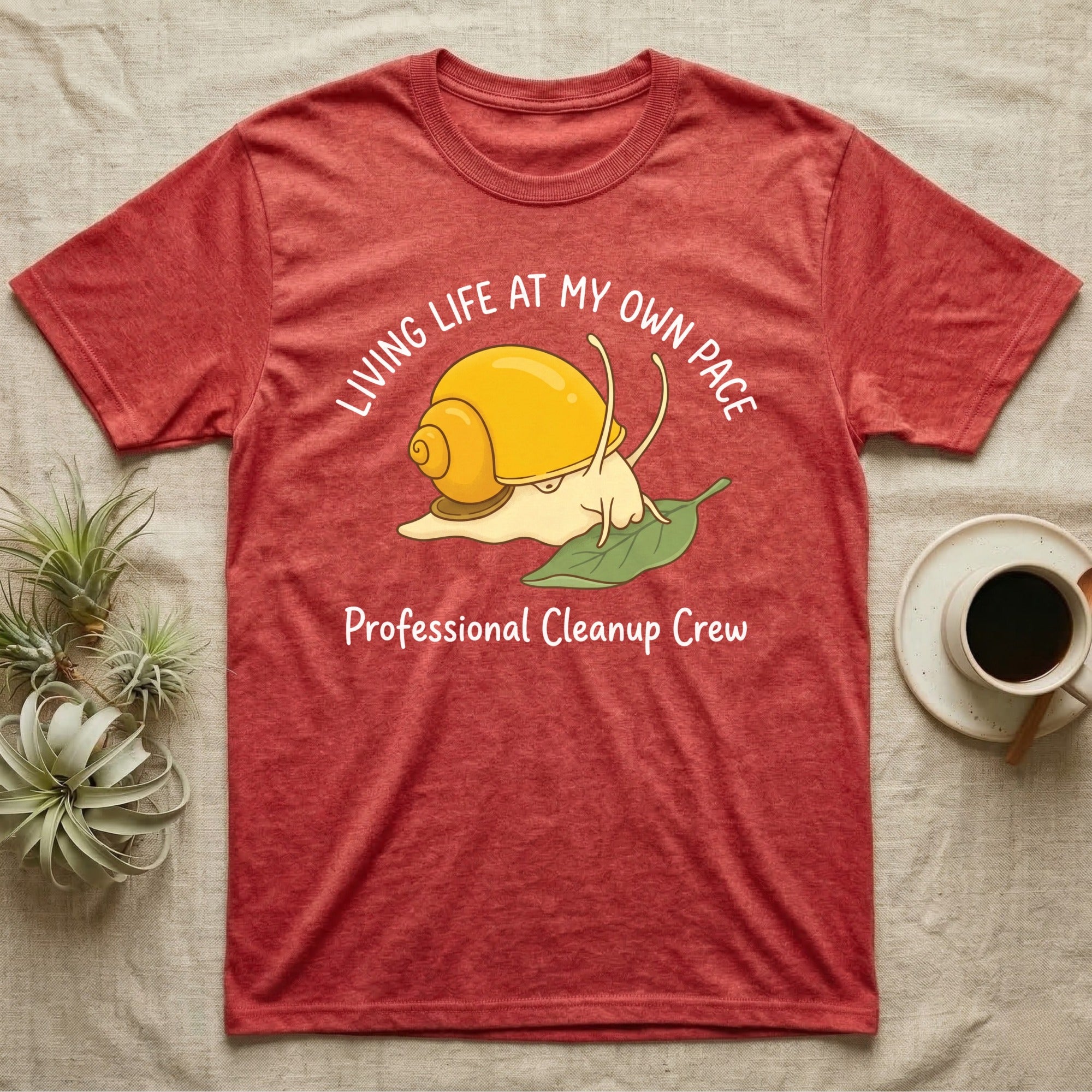 Red t-shirt with a cartoon snail and the text "Living life at my own pace, Professional Cleanup Crew."