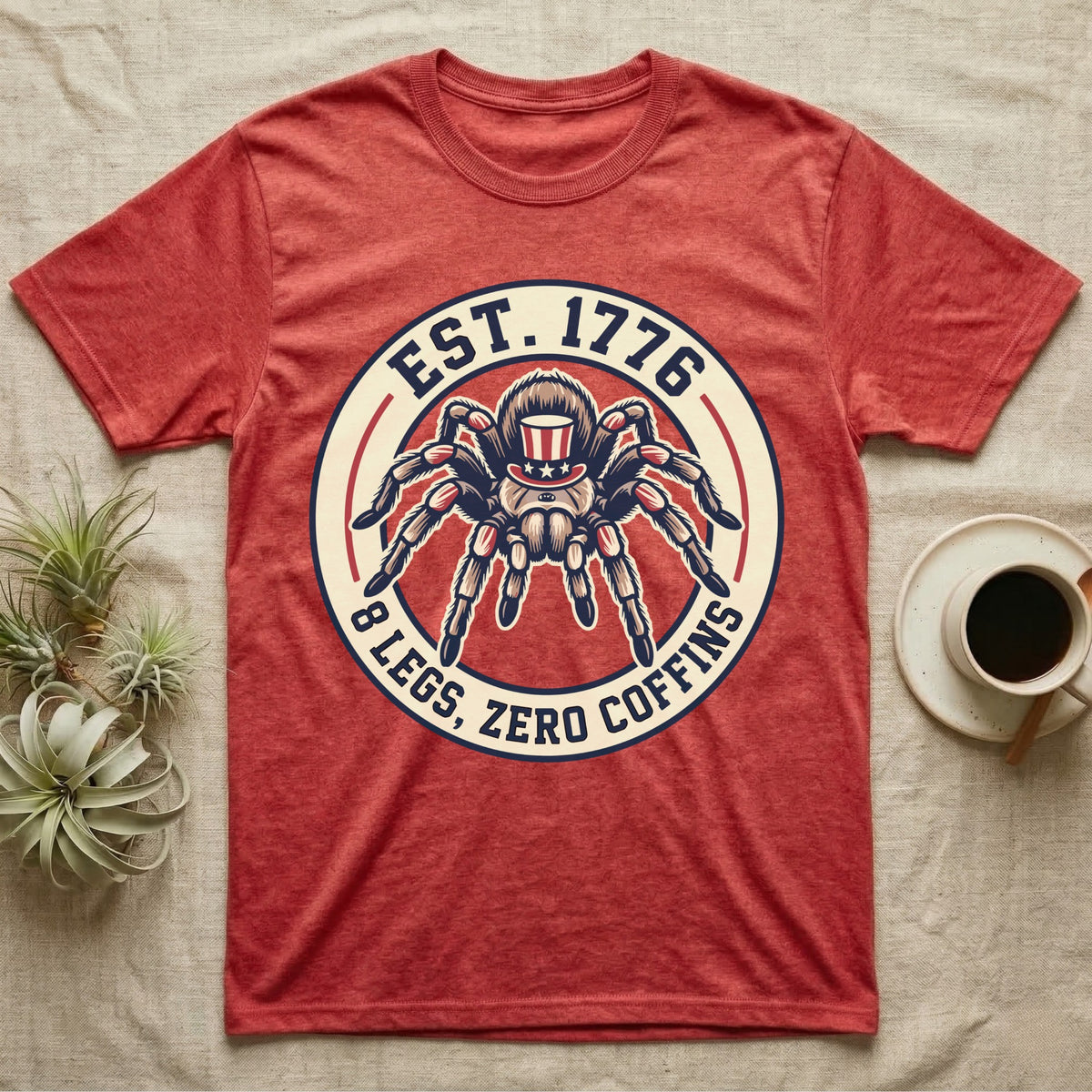 Tarantula Zero Coffins T-Shirt in Heather Red — Circular patch emblem of a tarantula in a top hat with arched text Est. 1776 and 8 Legs Zero Coffins.