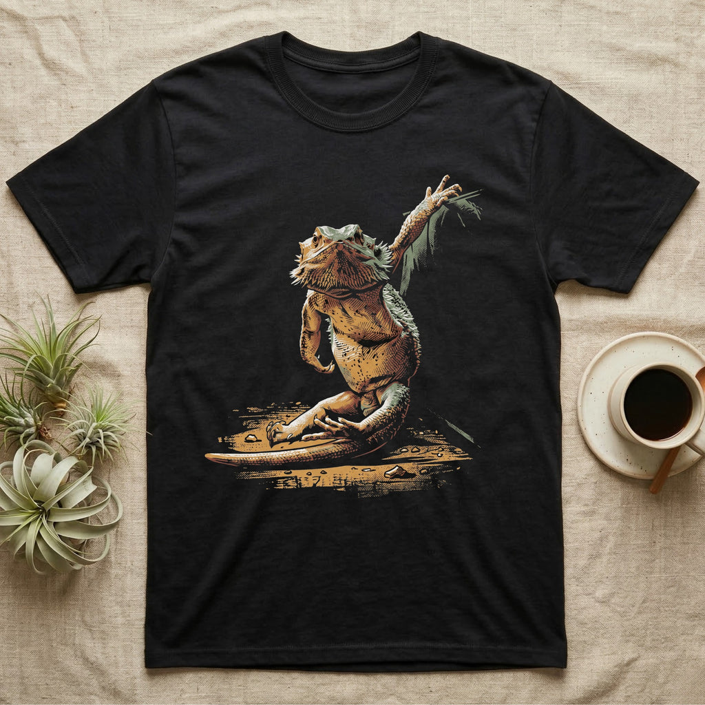 Vintage ink illustration of a bearded dragon seated with legs folded, one arm raised overhead toward a leafy frond, chin lifted, no on-shirt text. — shown on a Black tee.