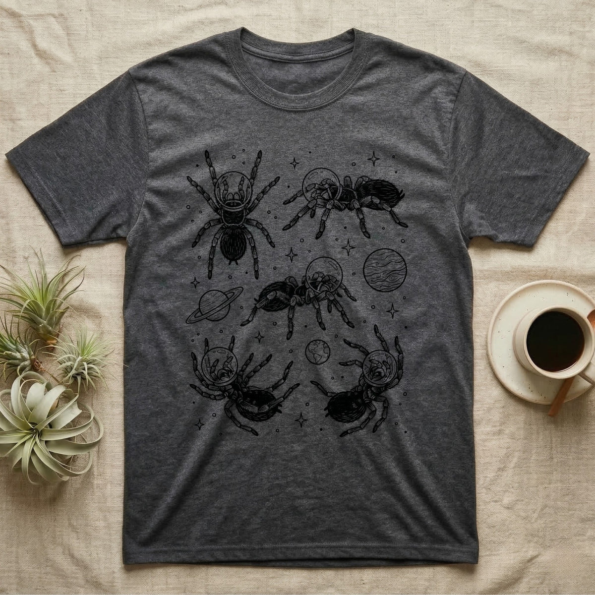 Tarantula Cosmic T-Shirt in Dark Heather — Vintage screen-print illustration of tarantulas in astronaut helmets floating in space, obsidian black monochromatic on dark grey background.