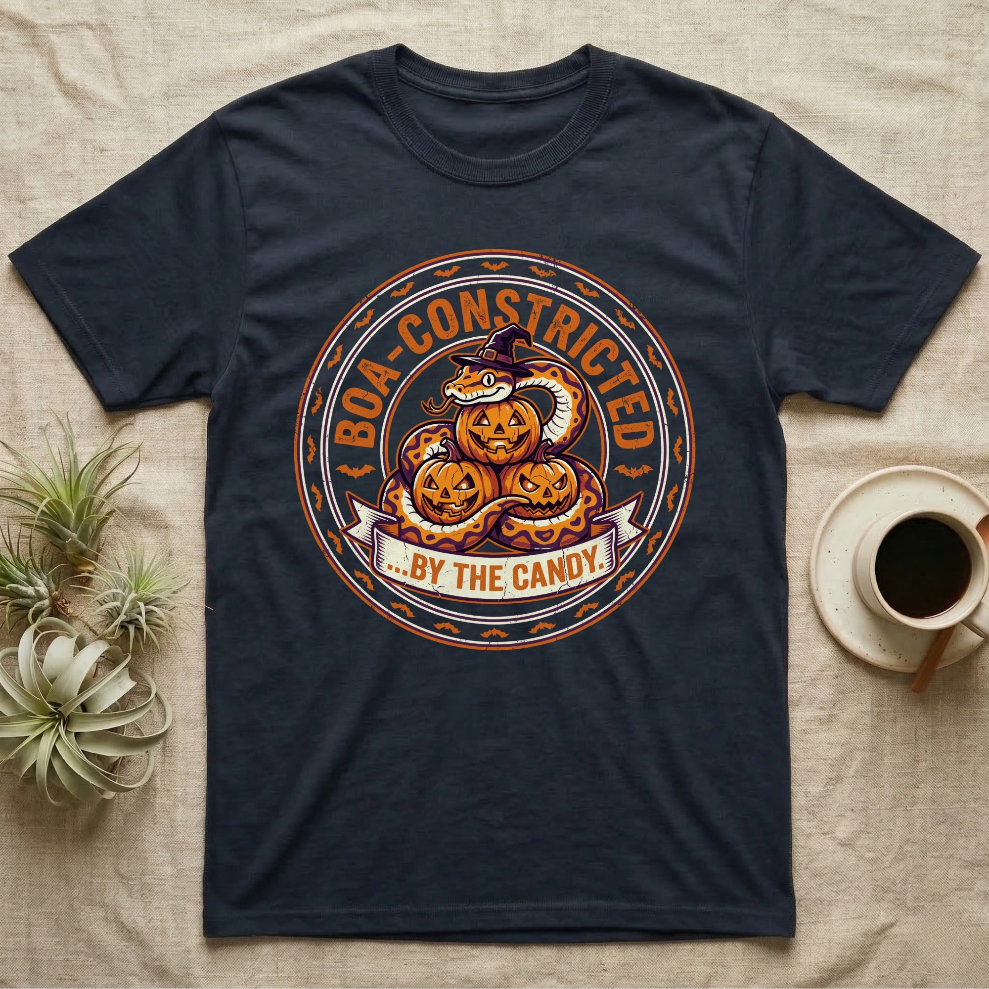 Ball Python Boa-Constricted Candy T-Shirt in Navy — Distressed badge of a witch-hatted ball python on three jack-o'-lanterns, "Boa-Constricted by the Candy."