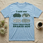 Ball Python Collector T-Shirt in Light Blue — Four engraved ball python morphs in tight coils between the words I said one and THAT WAS FOUR SNAKES AGO.