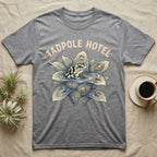 Tadpole Hotel Frog T-Shirt in Sport Grey — Whimsical naturalist illustration of a dart frog tucking tadpoles into a bromeliad Tadpole Hotel with hand-lettered marquee text.