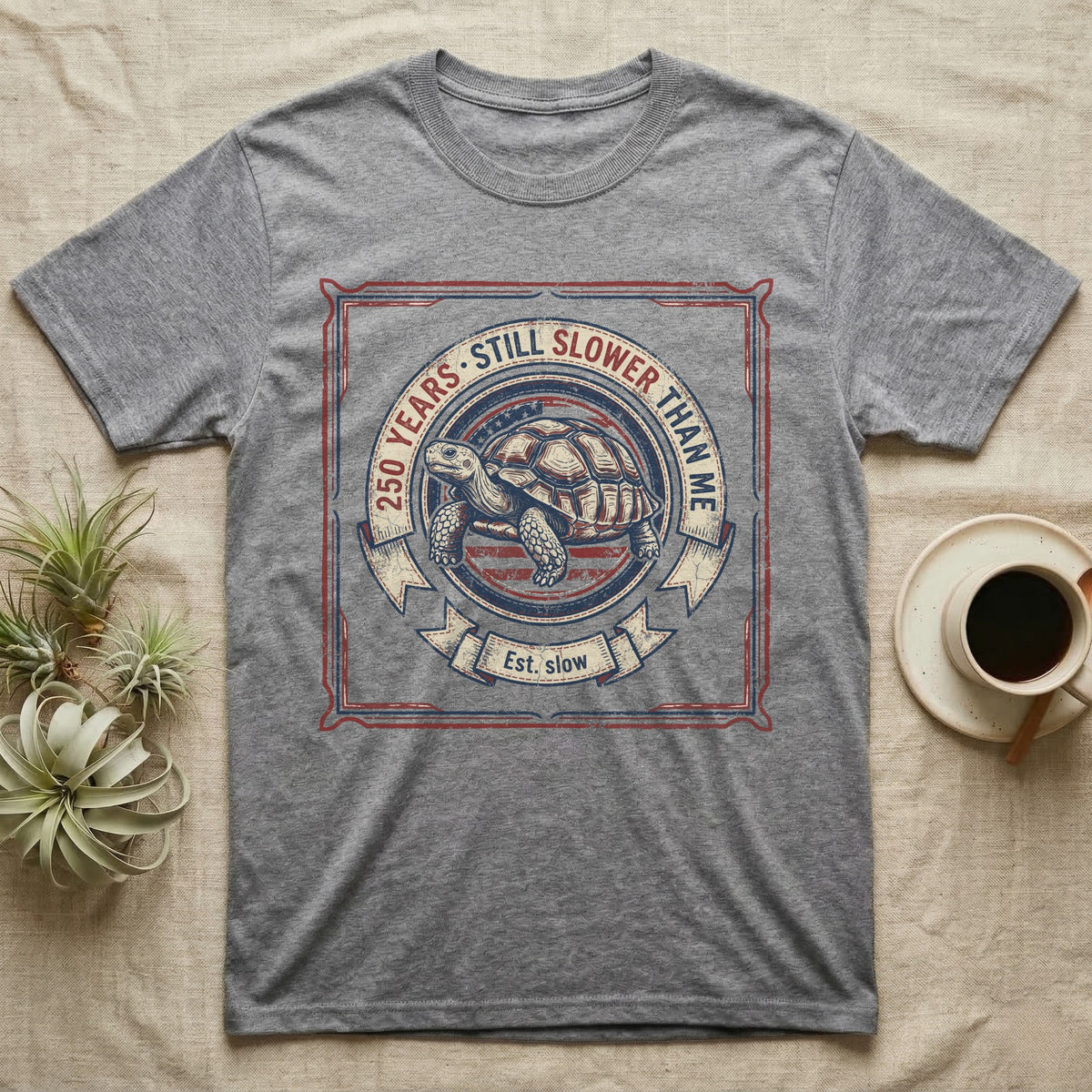 Slower Than Me Tortoise T-Shirt in Sport Grey — Vintage-Americana roundel illustration of a tortoise with a banner reading "250 Years, Still Slower Than Me."