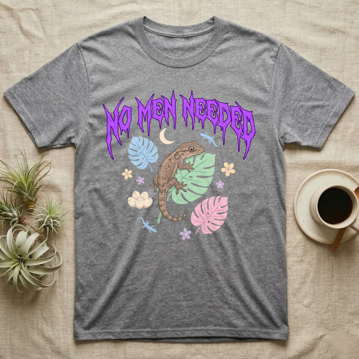 Mourning Gecko Feral T-Shirt in Sport Grey — Mourning gecko on a leaf flanked by clone silhouettes under a jagged violet metal "NO MEN NEEDED" wordmark.