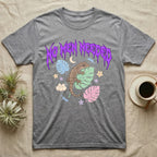 Mourning Gecko Feral T-Shirt in Sport Grey — Mourning gecko on a leaf flanked by clone silhouettes under a jagged violet metal "NO MEN NEEDED" wordmark.