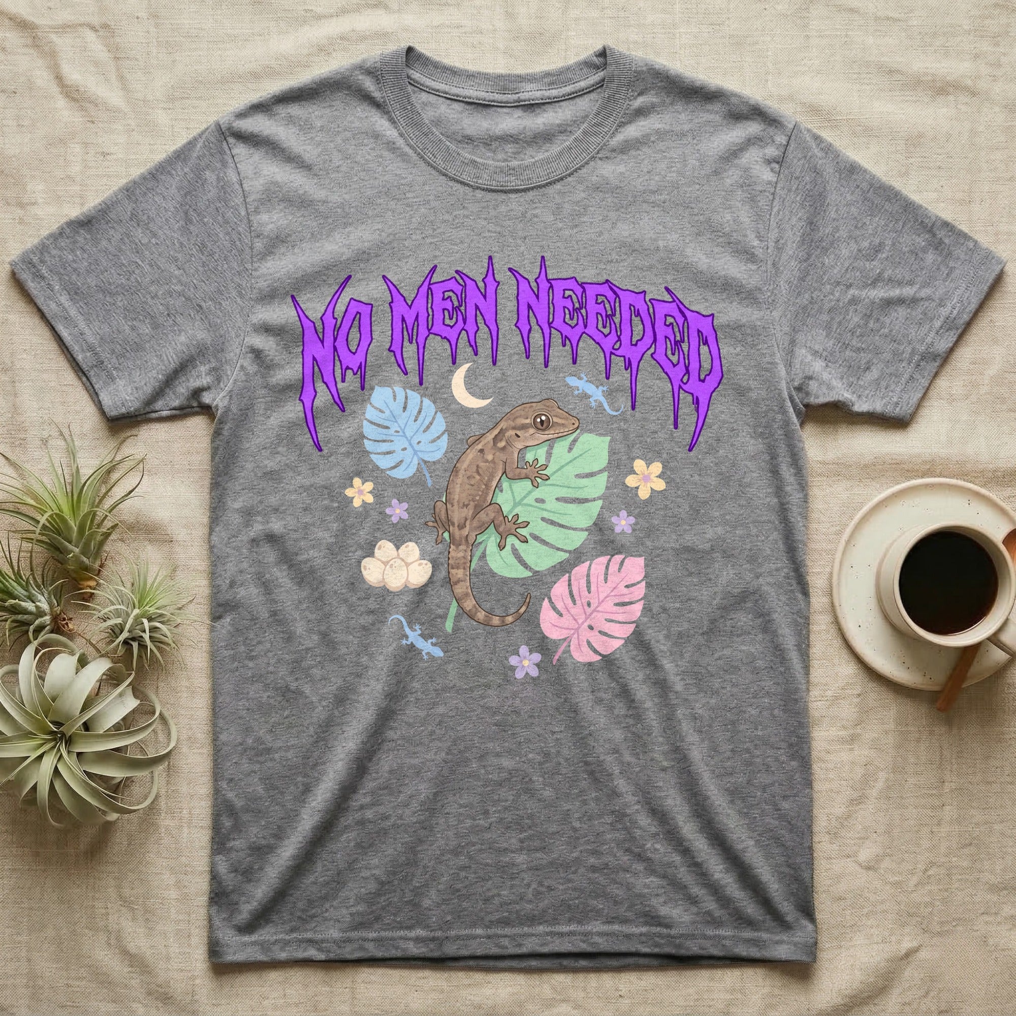 Mourning Gecko Feral T-Shirt in Sport Grey — Mourning gecko on a leaf flanked by clone silhouettes under a jagged violet metal "NO MEN NEEDED" wordmark.