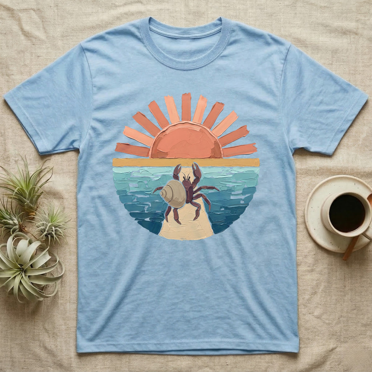 Hermit Crab Big Stretch T-Shirt in Light Blue — Palette-knife painted medallion of a Caribbean hermit crab at full stretch under a coral sunburst.