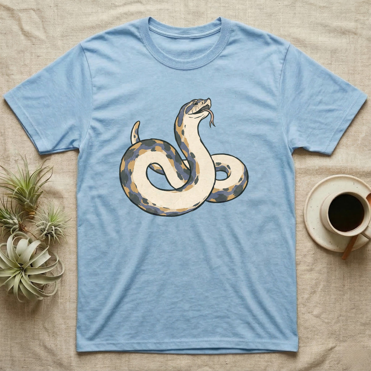 Hognose Play Dead T-Shirt in Light Blue — Ukiyo-e woodblock illustration of a western hognose snake playing dead belly-up with a deadpan serif caption beneath.