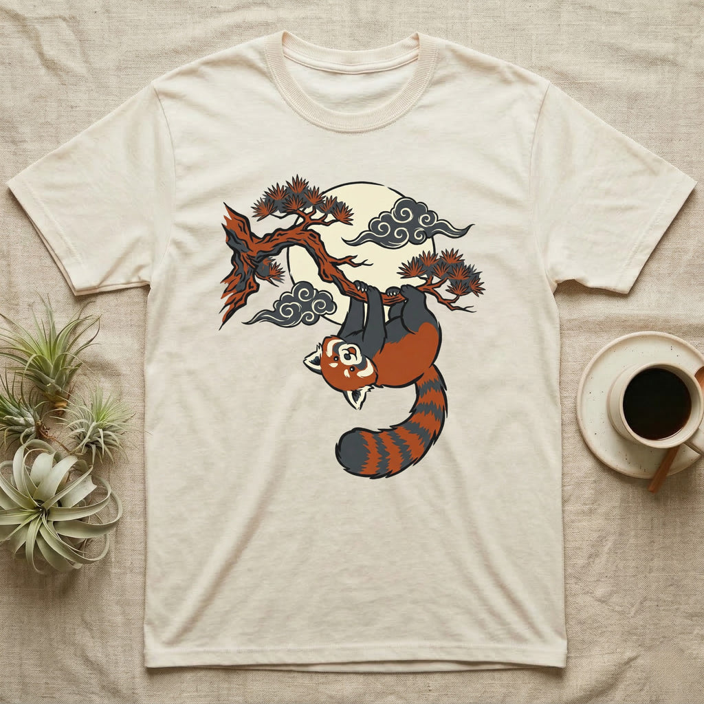 Cream t-shirt with red panda hanging from tree branch under moon.