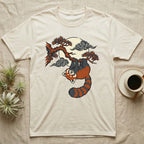 Cream t-shirt with red panda hanging from tree branch under moon.