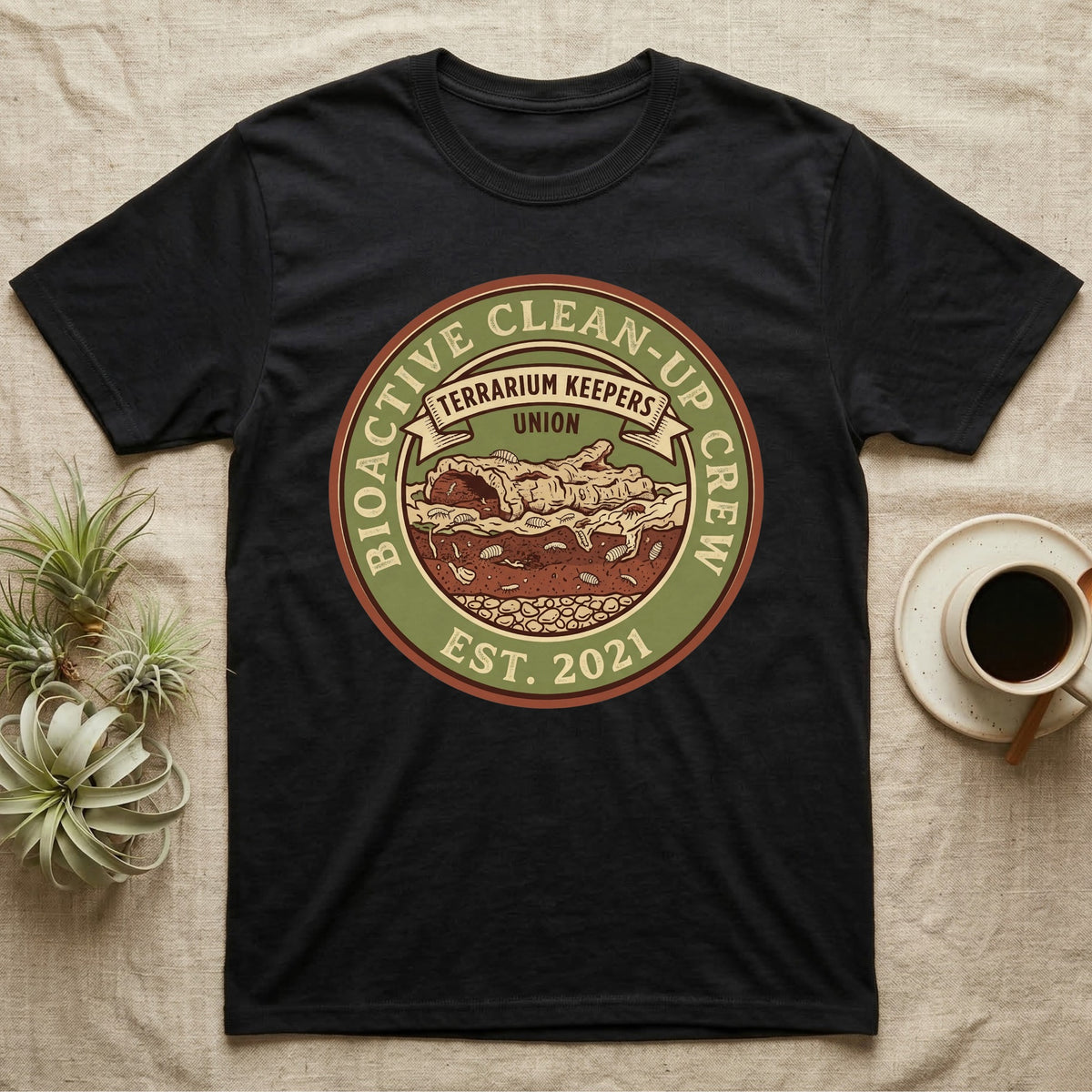 Isopod Terrarium Keepers Union T-Shirt in Black — Vintage union badge showing a cross-sectioned bioactive vivarium worked by isopods and springtails.