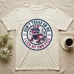 Crested Gecko 1776 T-Shirt in Natural — Distressed crest of a crested gecko in a top hat with text Don't Tread On Me and I Lick My Own Eyes.