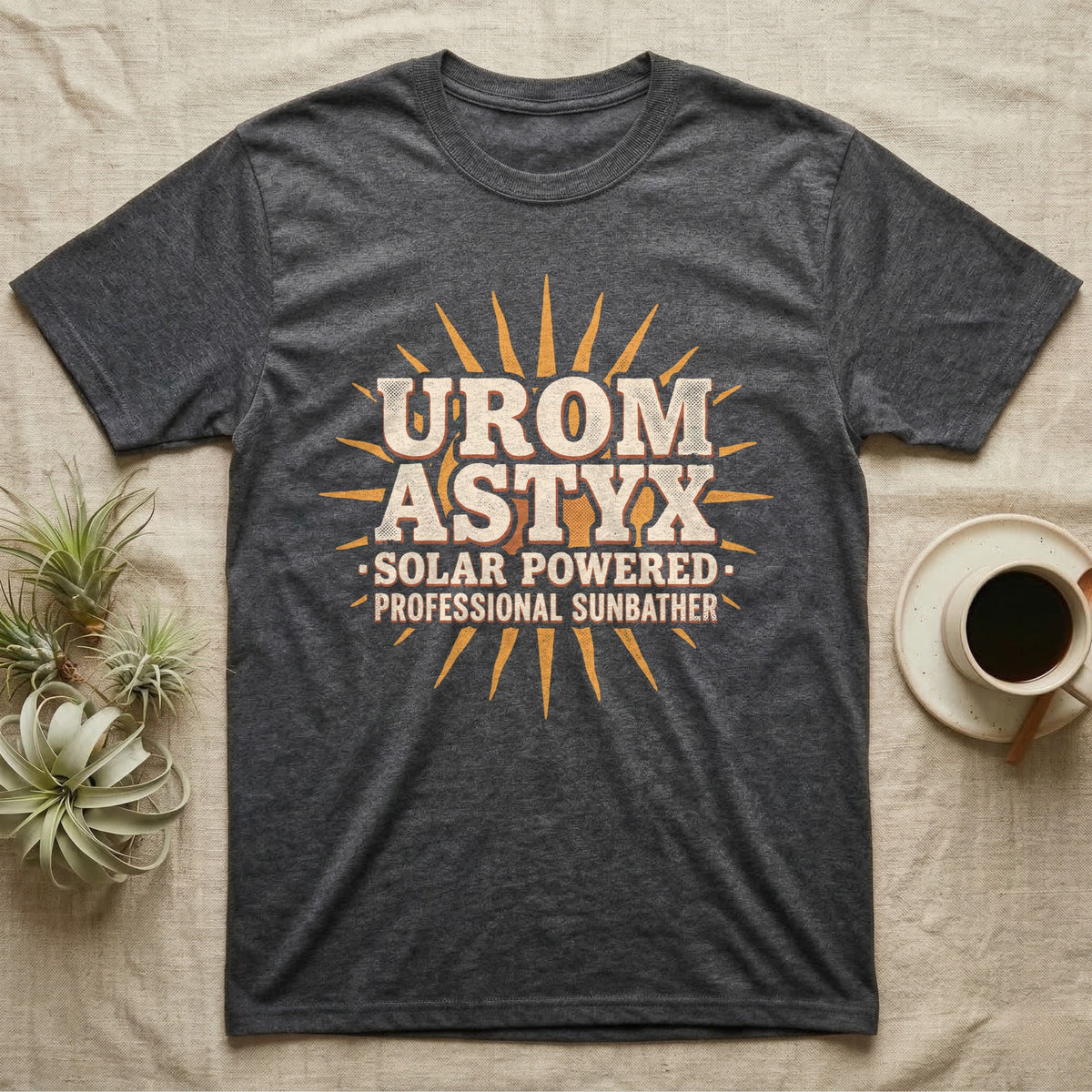 Solar Powered Uromastyx T-Shirt in Dark Heather — Desert-poster wordmark reading "Uromastyx Solar Powered Professional Sunbather" with a small radiating sun motif.