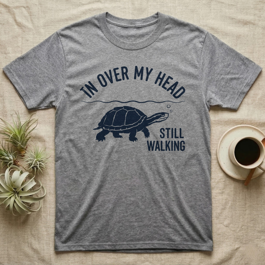 Musk Turtle Walking T-Shirt in Sport Grey — Navy silhouette of a musk turtle walking under arched words In Over My Head, beside Still Walking